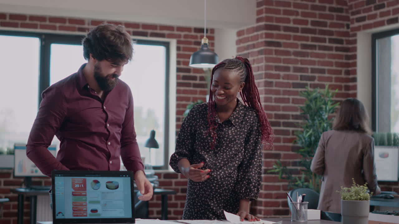 Multi ethnic team of people giving highfive while working