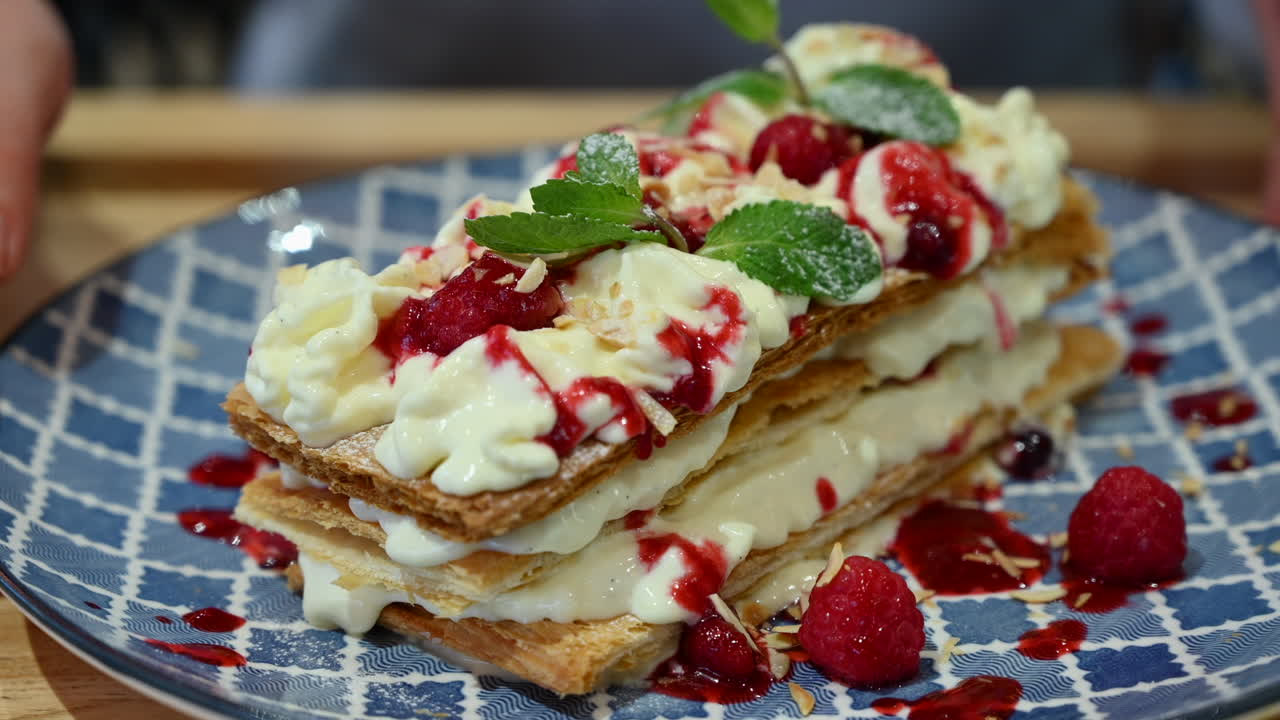 Millefeuille dessert at a restaurant in a blue plate