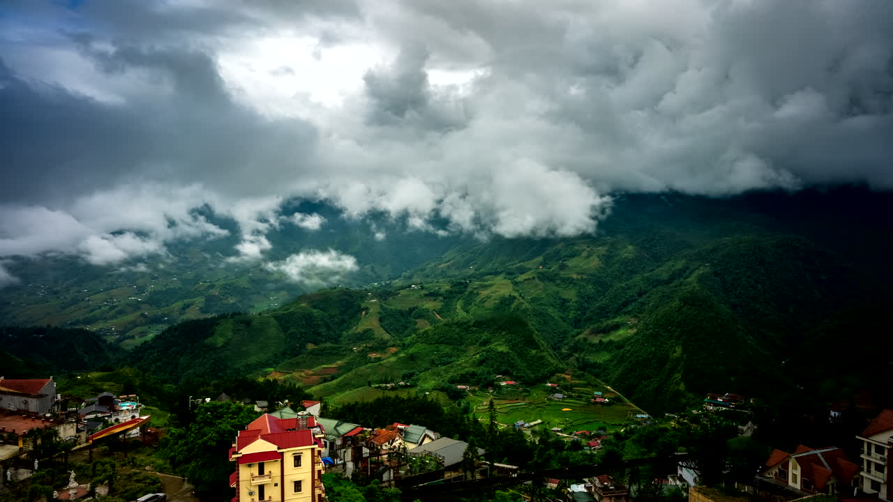 Dramatic Mountain Valley Landscape with Clouds and Fog