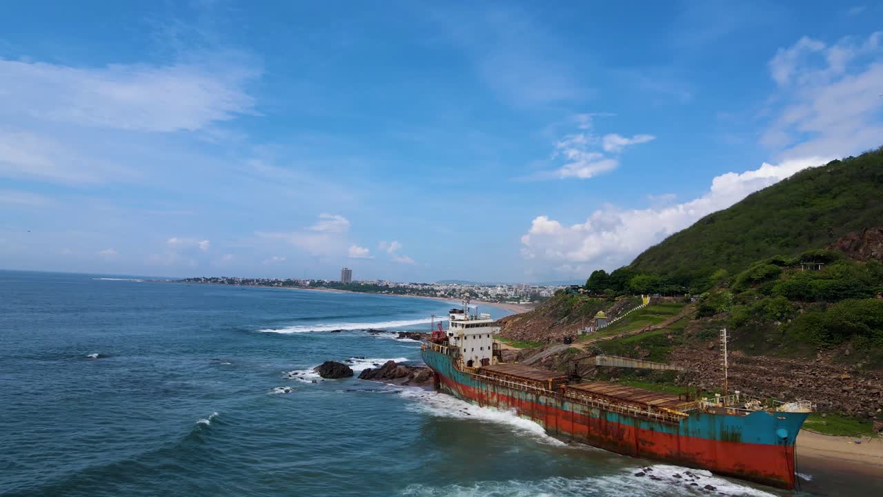 Stunning aerial drone shot of a shipwreck in Vizag, showcasing the haunting sight of the vessel against the blue ocean backdrop.