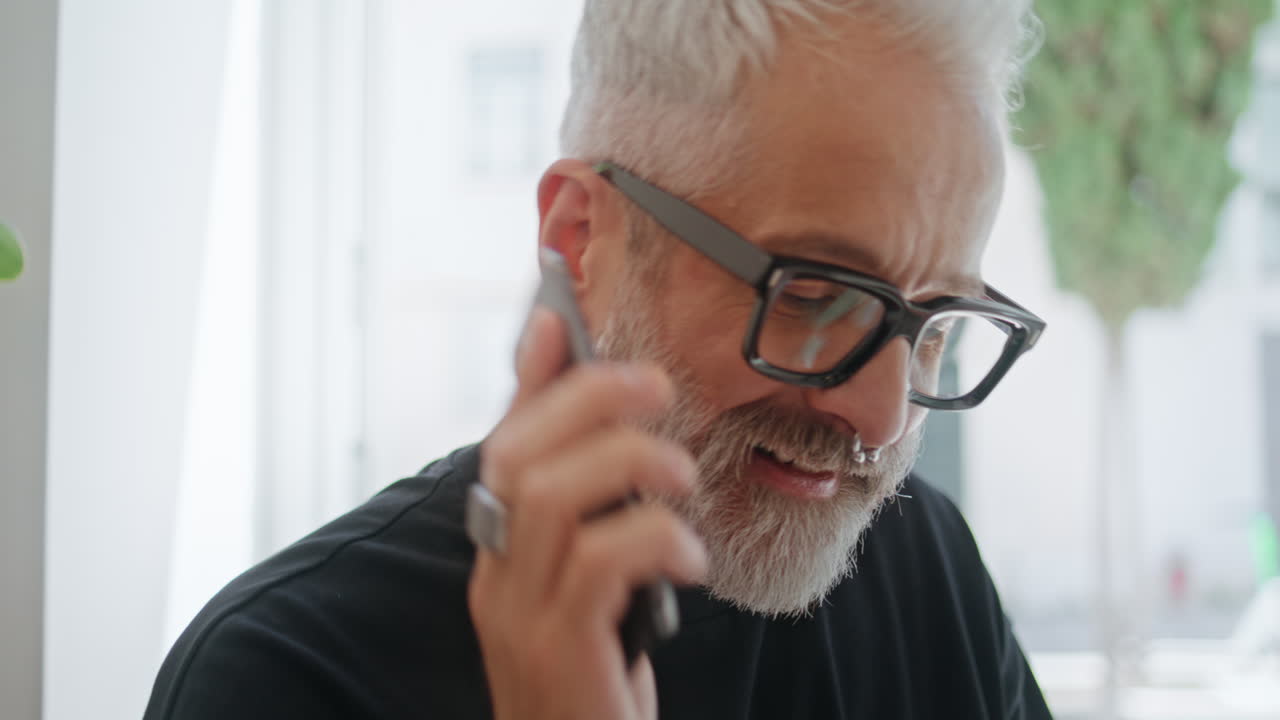 Stylish man chatting smartphone closeup. Handsome senior ending call working