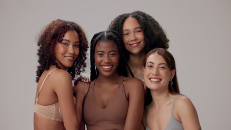 group of four diverse women smiling and laughing together