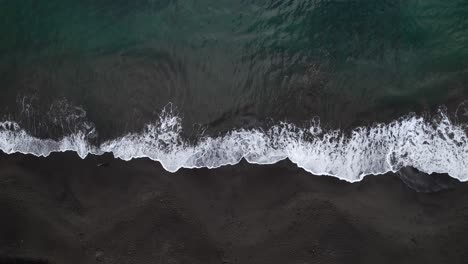 waves breaking on black sand beach, plage de grande anse bay, guadeloupe, french antilles