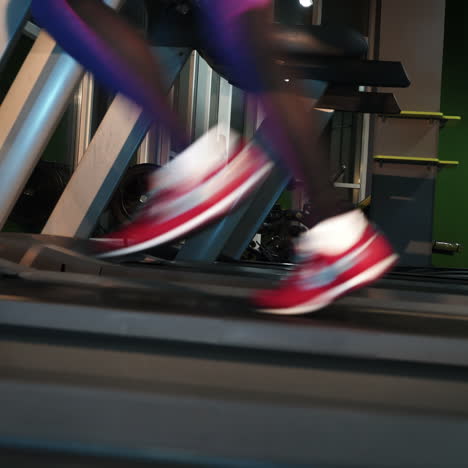 female muscular feet in sneakers running on the treadmill at the gym. concept for fitness, exercising and healthy lifestyle. square video