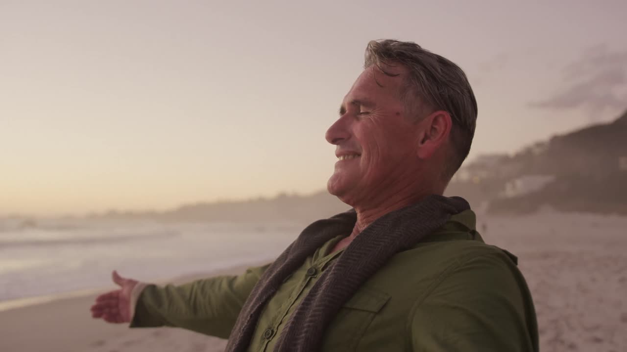 Active senior standing on beach