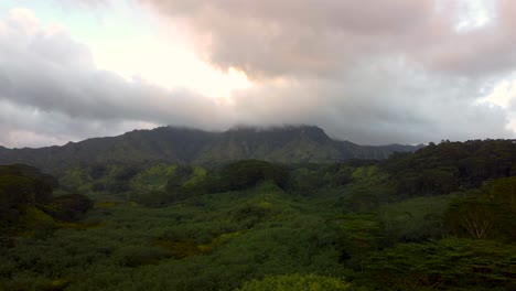 Espectacular-Sobrevuelo-Aéreo-Que-Revela-Una-Exuberante-Selva-Tropical,-Ríos,-Montañas-Y-Arroyos-Durante-La-Puesta-De-Sol-Con-Nubes-Rosadas