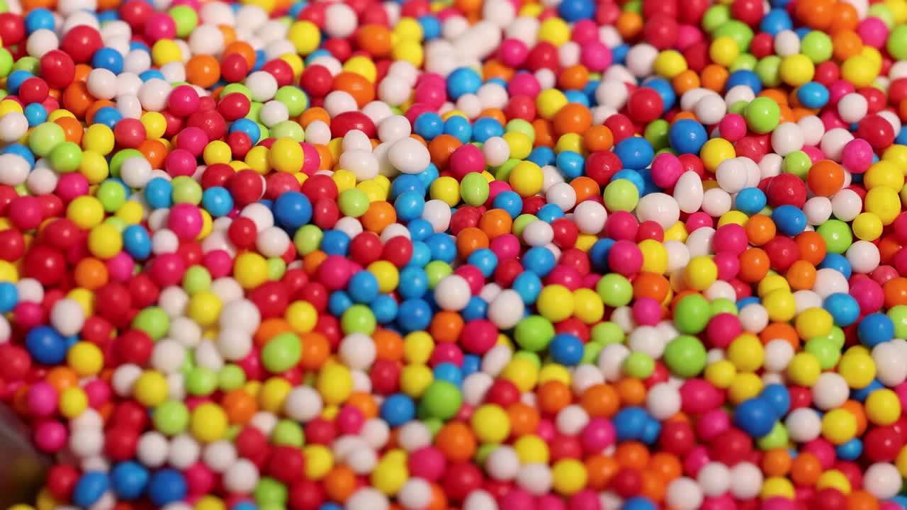 A vibrant close-up view of multicolored candy sprinkles, showcasing their bright and playful texture.