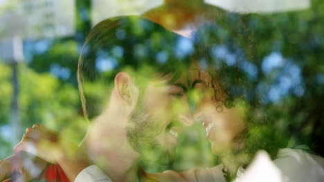 couple embracing and rubbing nose in restaurant