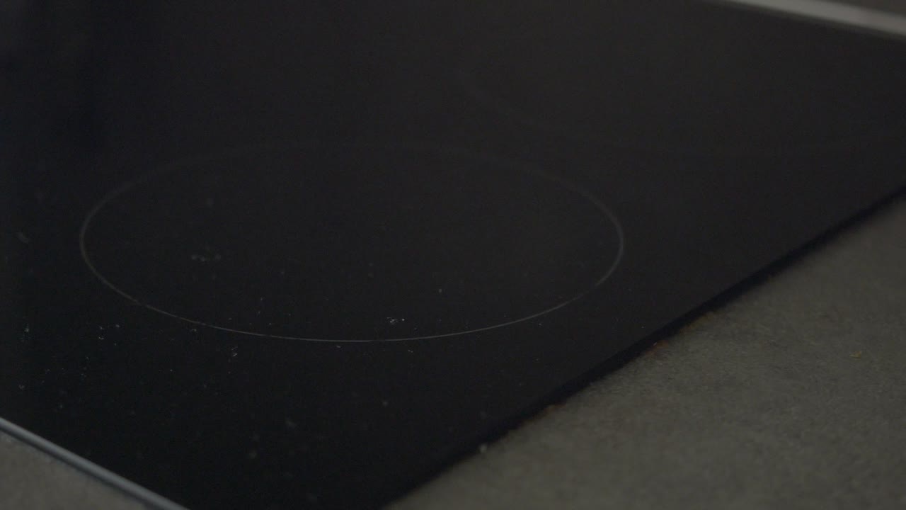 Close-up of a black electric stove cooktop