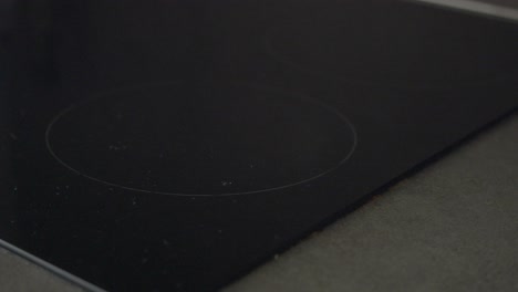 close-up of a black electric stove cooktop