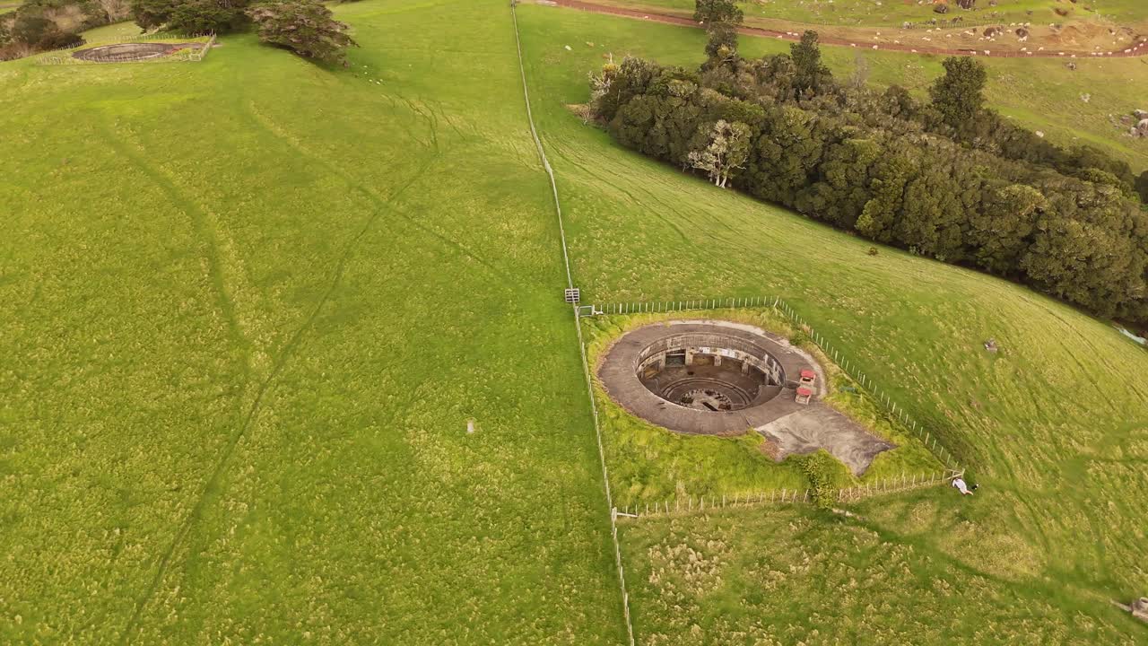A 4K aerial orbit shot of the tunnels and gun emplacements of Stony Batter, a Heritage 1 Listed WWII coastal defense fortress at the eastern end of New Zealand's beautiful Waiheke Island