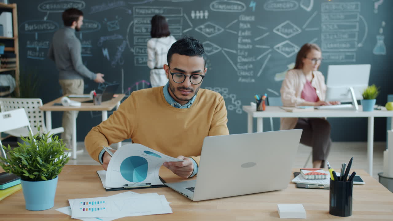 Business Team Working on Charts and Graphs in the Office