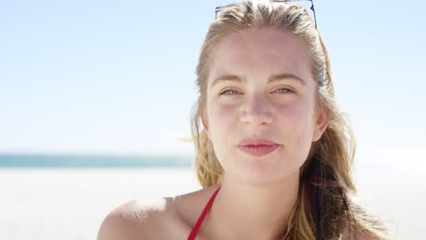 close up portrait of beautiful young teenage girl smiling on tropical beach slow motion