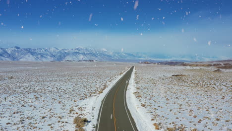 winding endless american rural road during heavy snowfall, aerial view