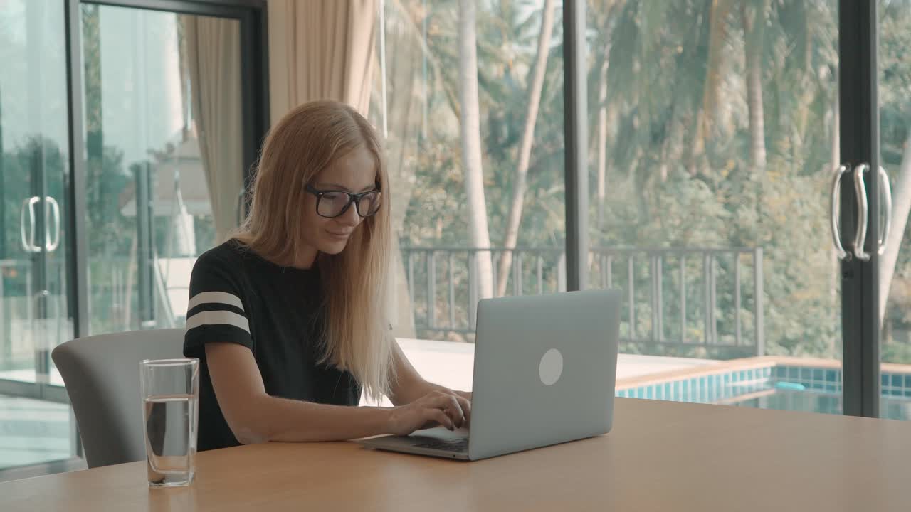 Happy Woman Working Remotely on Laptop in Modern Home