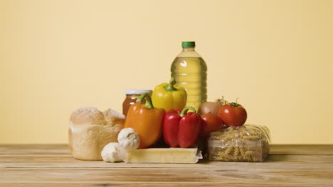 Studio-Shot-Of-Basic-Food-Items-On-Wooden-Surface-And-White-Background-1