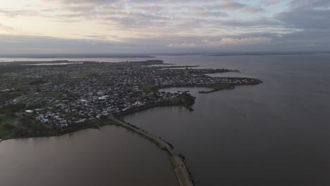 Aerial View of a Town on the Coast of a Lake at Sunset