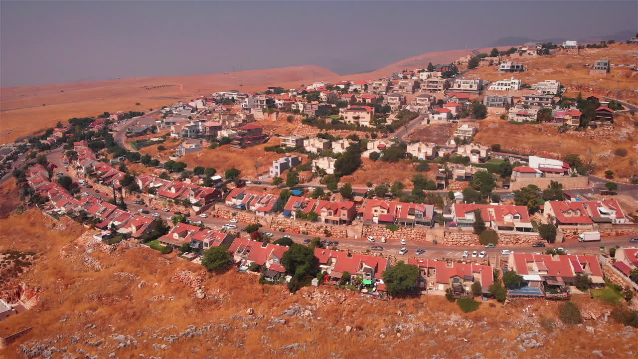 Small Village with red rooftops in the desert Heat Aerial