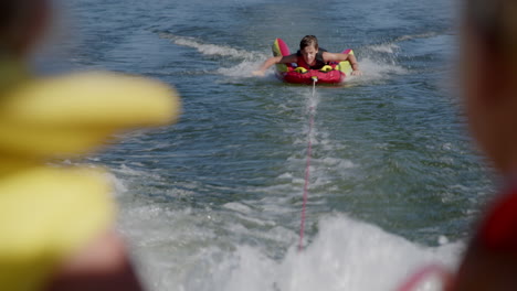 boy tubing on a lake