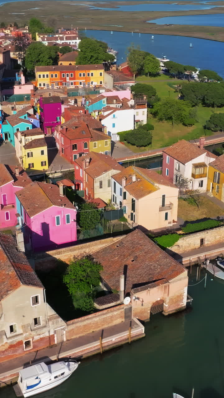 Aerial drone view of the colourful houses of Burano Island, Italy. Vertical