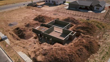 A drone shot slow push in on a foundations and basement walls that had just been poured