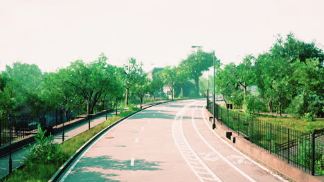 Empty-asphalt-road-in-city-with-trees