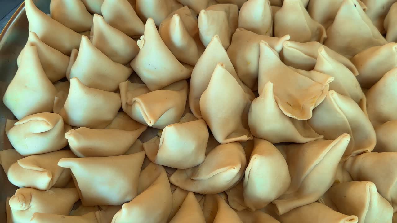 camera spins around uncooked raw samosa