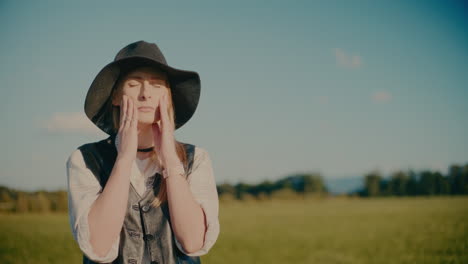 young woman with hands clasped against sky