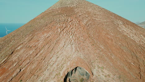 aerial view in reverse over the galdar mountain and revealing the herrera cave