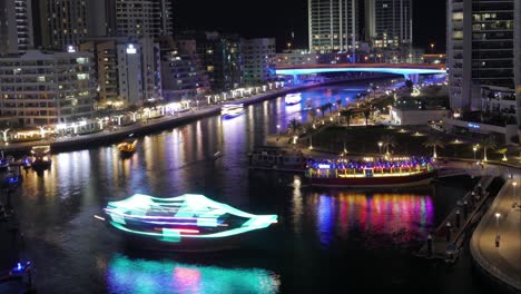 the beautiful, busy dubai marina during the night - time lapse