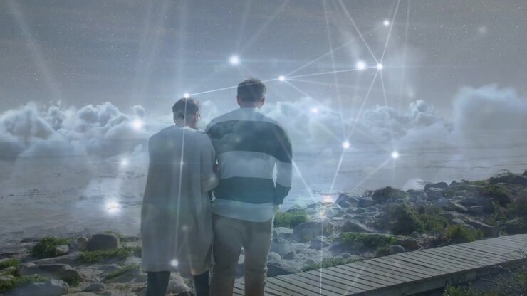 Couple linking arms walking closely along rocky boardwalk, tech nodes pulsing, flaring across backs