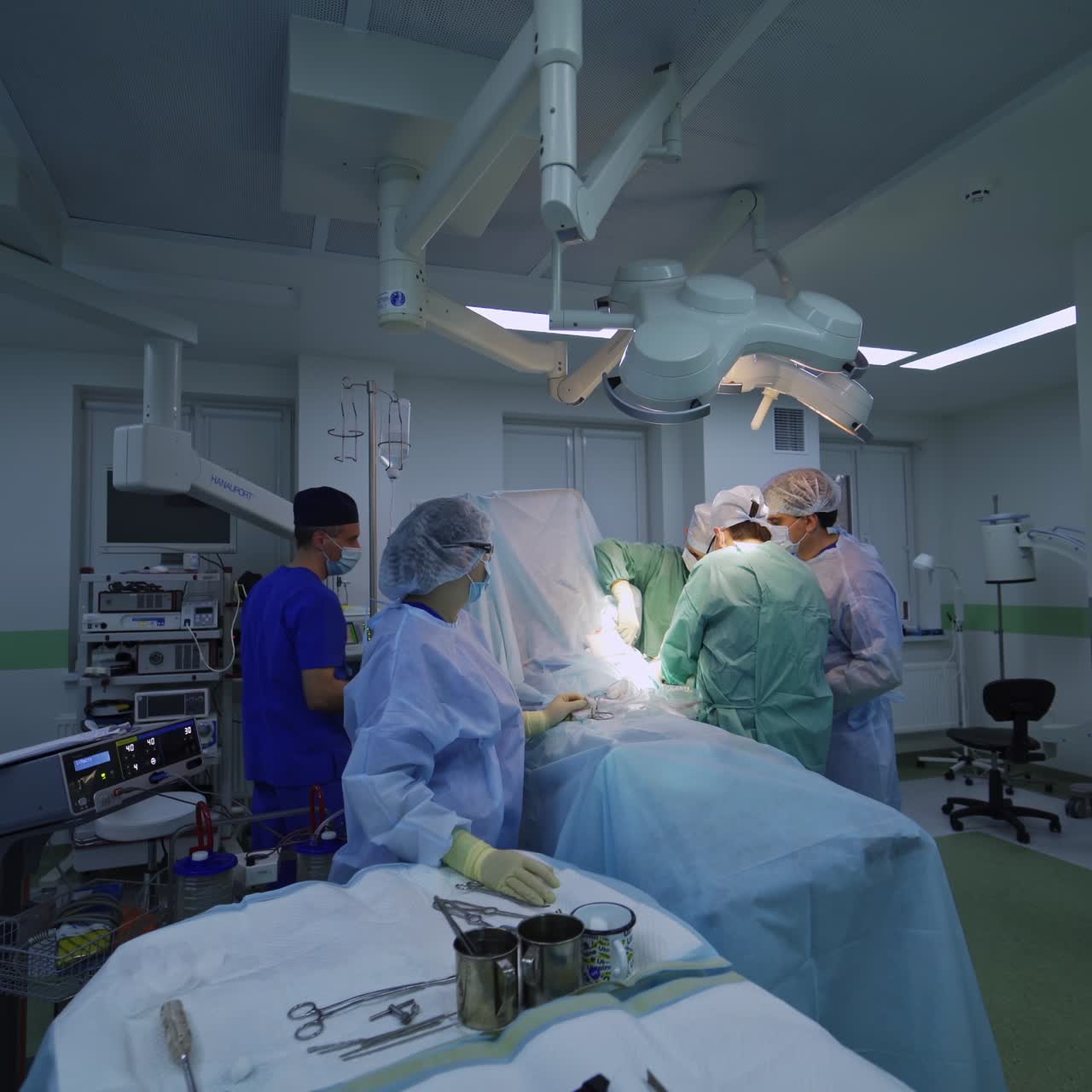 Large medical team operating the patient. Modern surgery room in the up-to date operational theatre