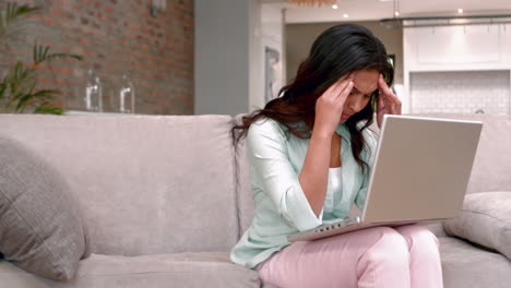 stressed woman sitting in front of laptop