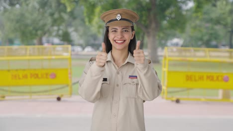 happy indian female police officer doing thumbs up