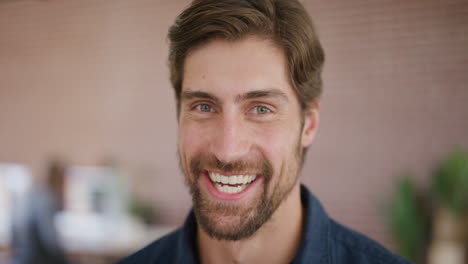 close-up-portrait-of-handsome-young-man-laughing-happy-entrepreneur-enjoying-success-slow-motion