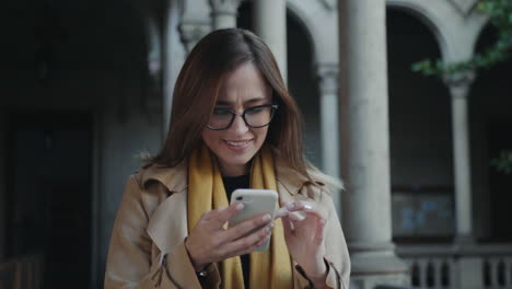 estudiante usando un teléfono inteligente en el pasillo