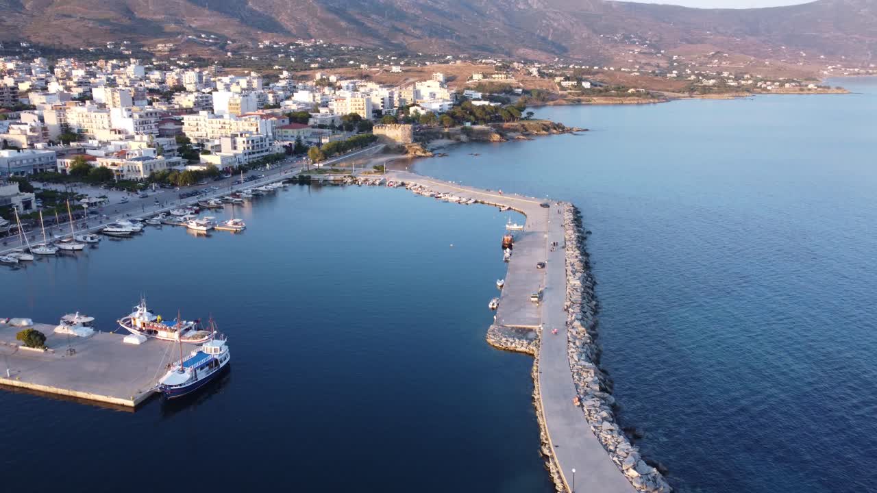 el puerto deportivo de una pequeña ciudad en una calmada y cálida tarde de verano | fotografía aérea del puerto de karystos en evoia, grecia | 4k