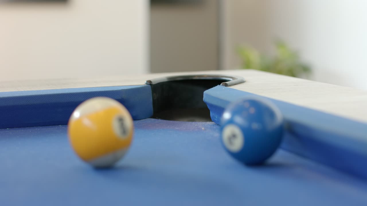Red 3-ball rolling from left and colliding with yellow and blue balls nudging toward corner pocket