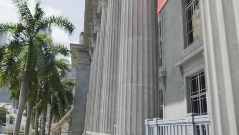 close up on the tall pillars of the national art gallery in singapore - reveal shot