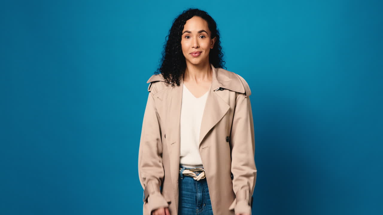 Excited woman in a trench coat and jeans