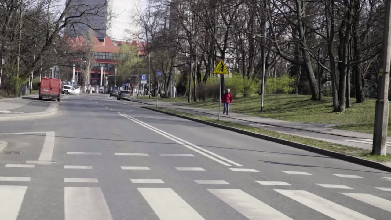 Empty city no traffic without cars in big european city shot on the road with only one pederastian pandemic epidemy in slow motion