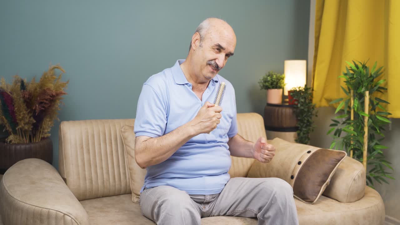 The old man sings to himself at home, he is relaxed and happy.