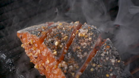 a close up slow motion shot from the top of salted fish being smoked