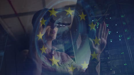 Animation-of-european-union-stars-and-data-over-caucasian-woman-with-vr-headset-by-computer-servers