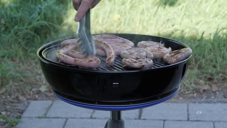 checking up on weekend barbeque grilled hotdog sausages