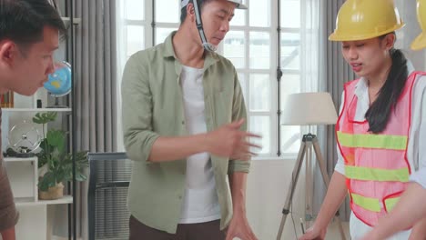 three asian engineers with helmets sharing ideas about work to a man at the office, angry colleagues debate fight over paperwork