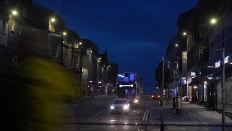 4k stylised timelapse of a busy road intersection at dusk in edinburgh in scotland in united kingdom with cars and people passing by