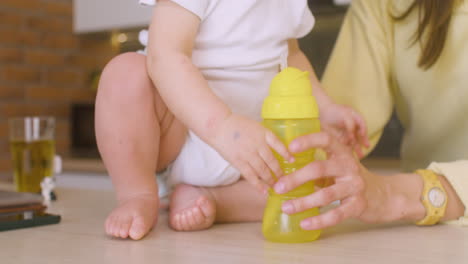 woman holding her baby on the kitchen counter 1