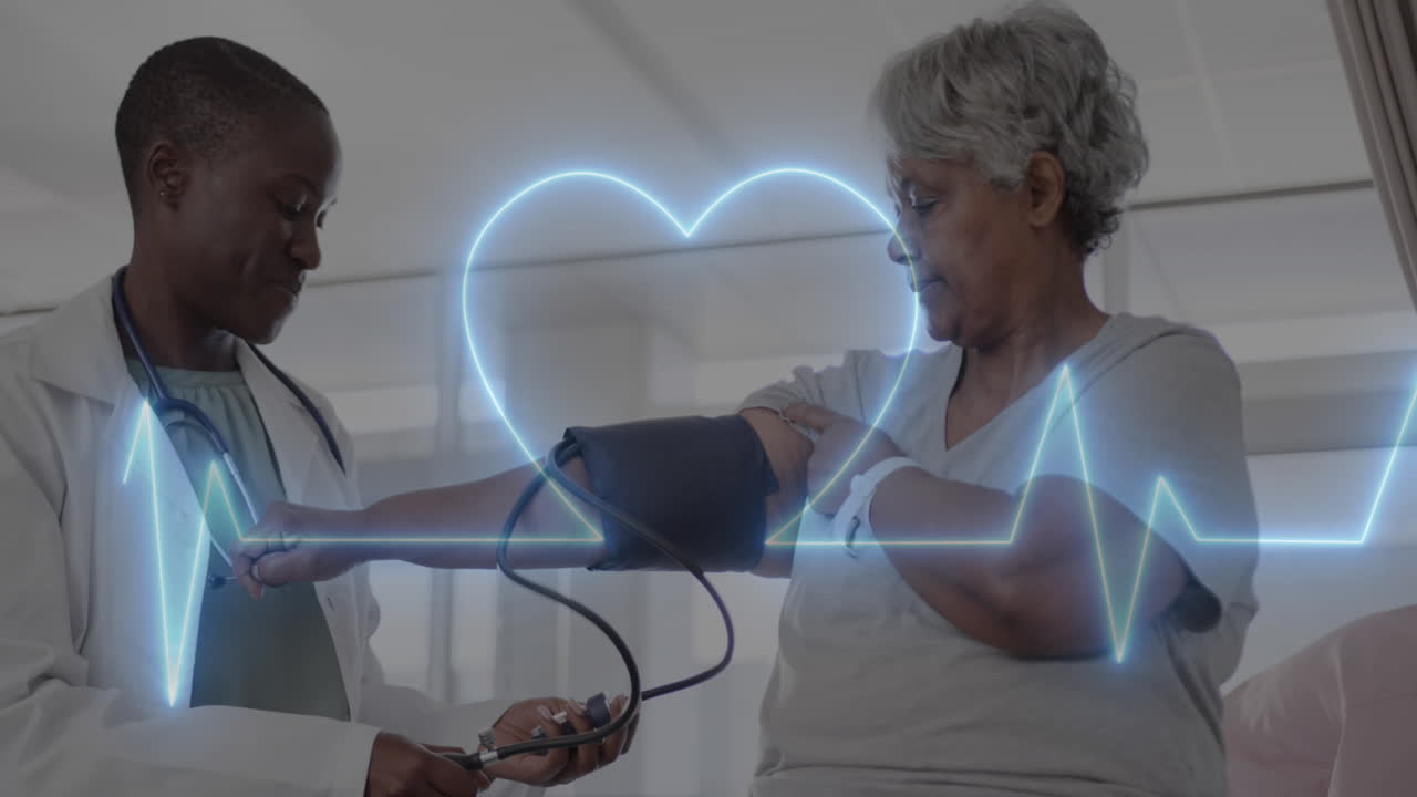 Animation of cardiograph and heart over diverse senior female patient and doctor taking pressure