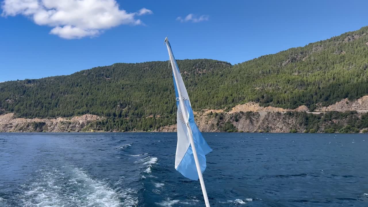 Beautiful view of a boat sailing through the waters with Argentine flag in Patagonia